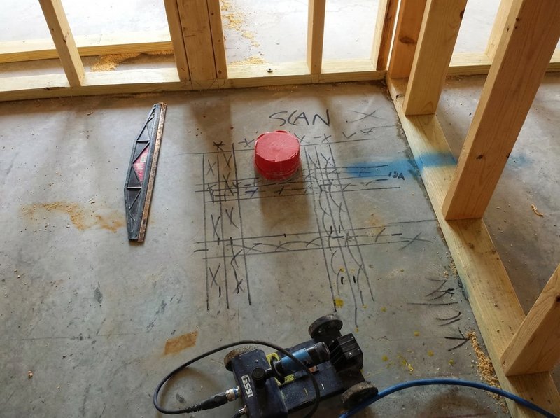 Concrete floor marked after GPR scan showing safe drilling locations